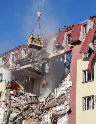 Rescuers work at a site an apartment building hit by a Russian drone strike in Odesa